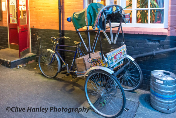Outside the bar was a bicycle rickshaw.