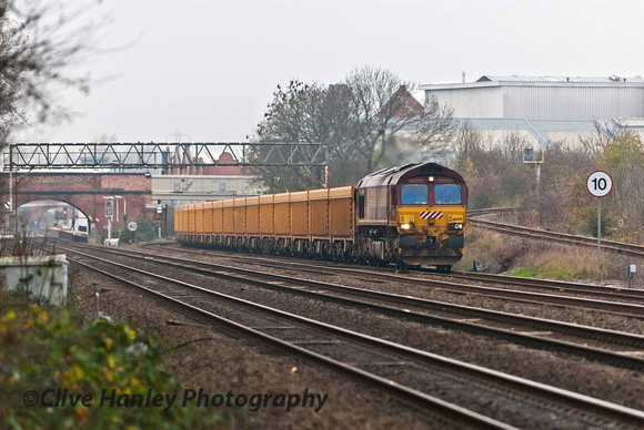 66249 hauls a freight on the slow line and is passing the spur onto the GCR North.