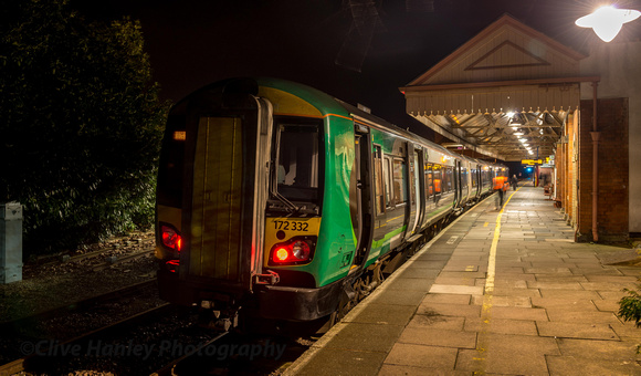 The London Midland 21.23 service from Birmingham has arrived at platform 1. The driver has exited his cab and is about to pass the guard who will take his place for the departure.