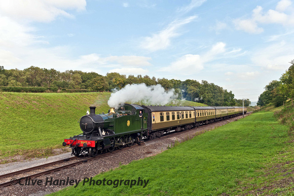 5542 brings its train through the verdant pastures of Dixton cutting.