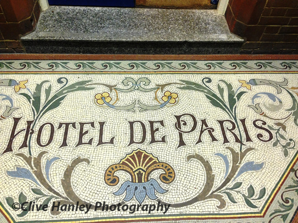The mosaic stands at the entrance to the Hotel de Paris.