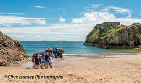 Join the queue for the ferry crossing on Tenby beach.