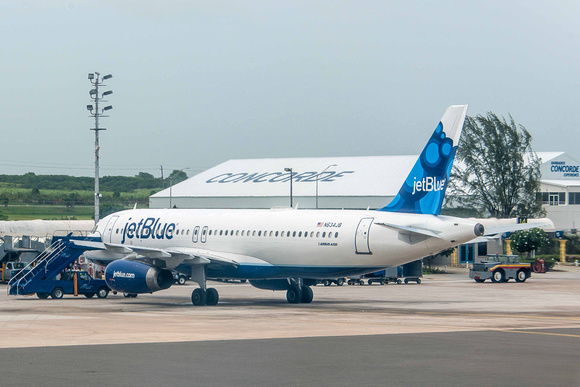 An Airbus A320-232 operated by JetBlue Airways. But look what's behind it... CONCORDE