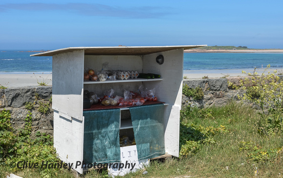 A stop at Vazon bay I caught a shot of one of many honesty fruit/veg/eggs stalls. NB... CCTV!