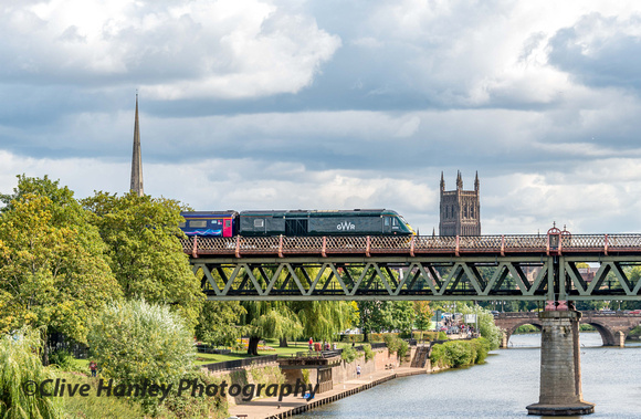 The 14.35 from Great malvern to London Paddington is seen crossing the River Severn bridge with the cathedral tower in the background.