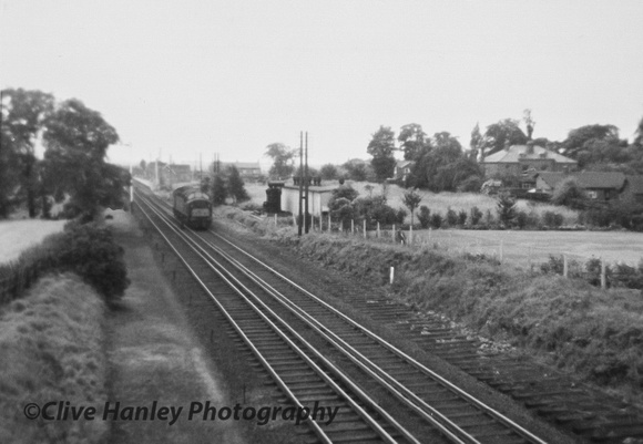 Poverty Lane bridge. A photo of a Class 40 diesel running north light engine. The siding on the left has clearly been lifted a while ago but the sleepers on the right survive.