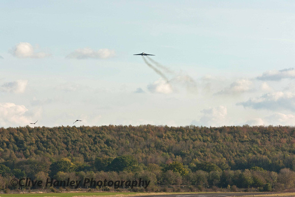 XH558 appears from over the hill.