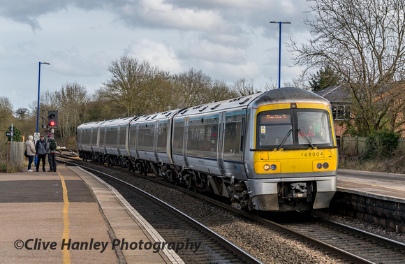 Unit 168004 hurries through Hatton station towards Birmingham.