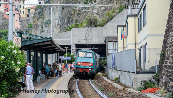 A south bound train arrives at Manarola