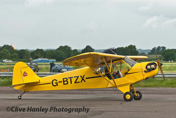 9.02am. G-BTZX Piper J3C-65Cub arrives and was "batted" through to the display area.