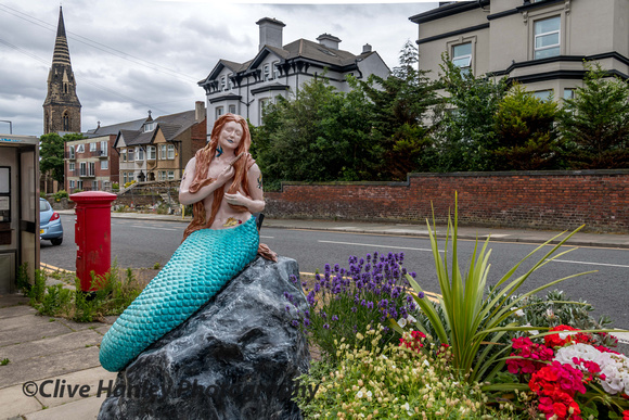 Outside New Brighton station.A mermaid.