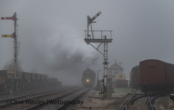Out of the gloom 60163 Tornado arrives at the south siding to collect the freight train.