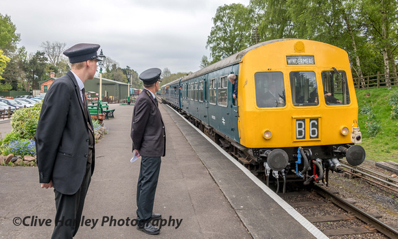 The DMU pulls into Rothley station watched by the station staff.