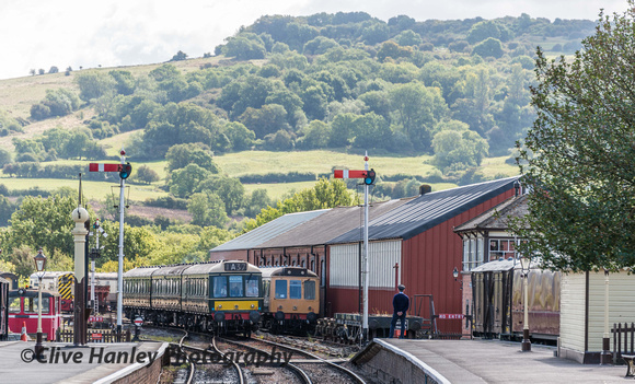 The DMU slowly approaches Winchcombe. The signalman waits at the platform end to take the token.